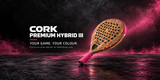 A single padel racket shown at an angle on a dark reflective surface with pink mist and lighting. Large text on the left reads 'CORK PREMIUM HYBRID III' with smaller text 'YOUR GAME.