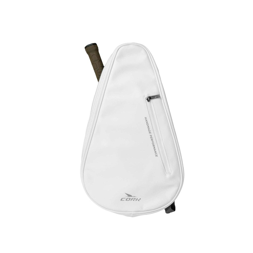 A white teardrop-shaped CORK padel bag with a vertical zippered pocket and a dark brown grip visible at the top, shown on a plain white background.